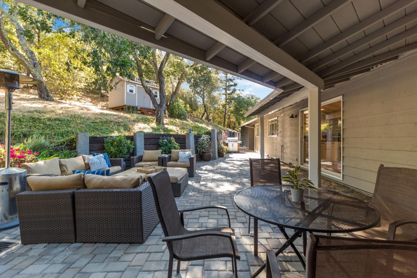 335 Harcross Road Woodside, CA 94062 - Photo 53 of 72 a view of a patio with table and chairs and potted plants