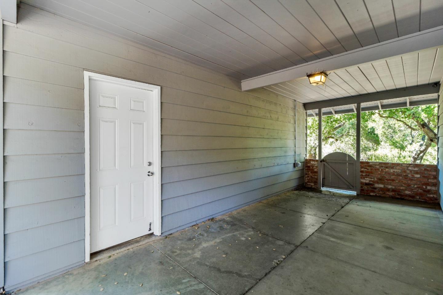 335 Harcross Road Woodside, CA 94062 - Photo 56 of 72 a view of a porch with furniture and floor to ceiling window