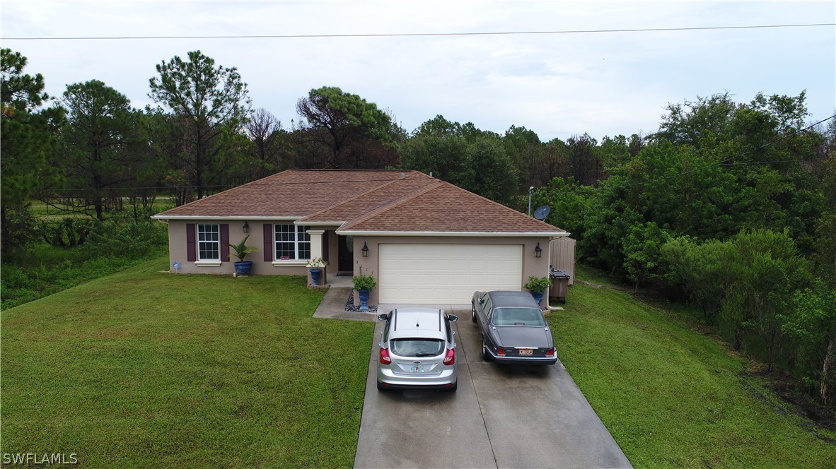 3115 Meadow Road Lehigh Acres, FL 33974 - Photo 1 of 23 a aerial view of a house with garden