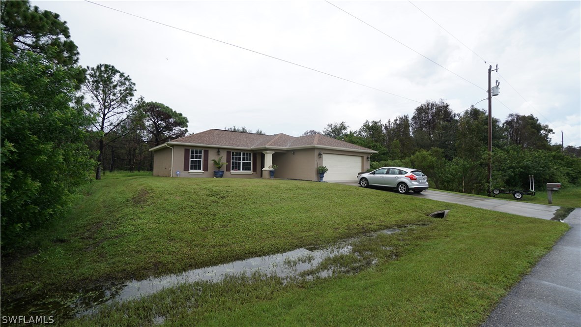 3115 Meadow Road Lehigh Acres, FL 33974 - Photo 20 of 23 a house view with a garden space