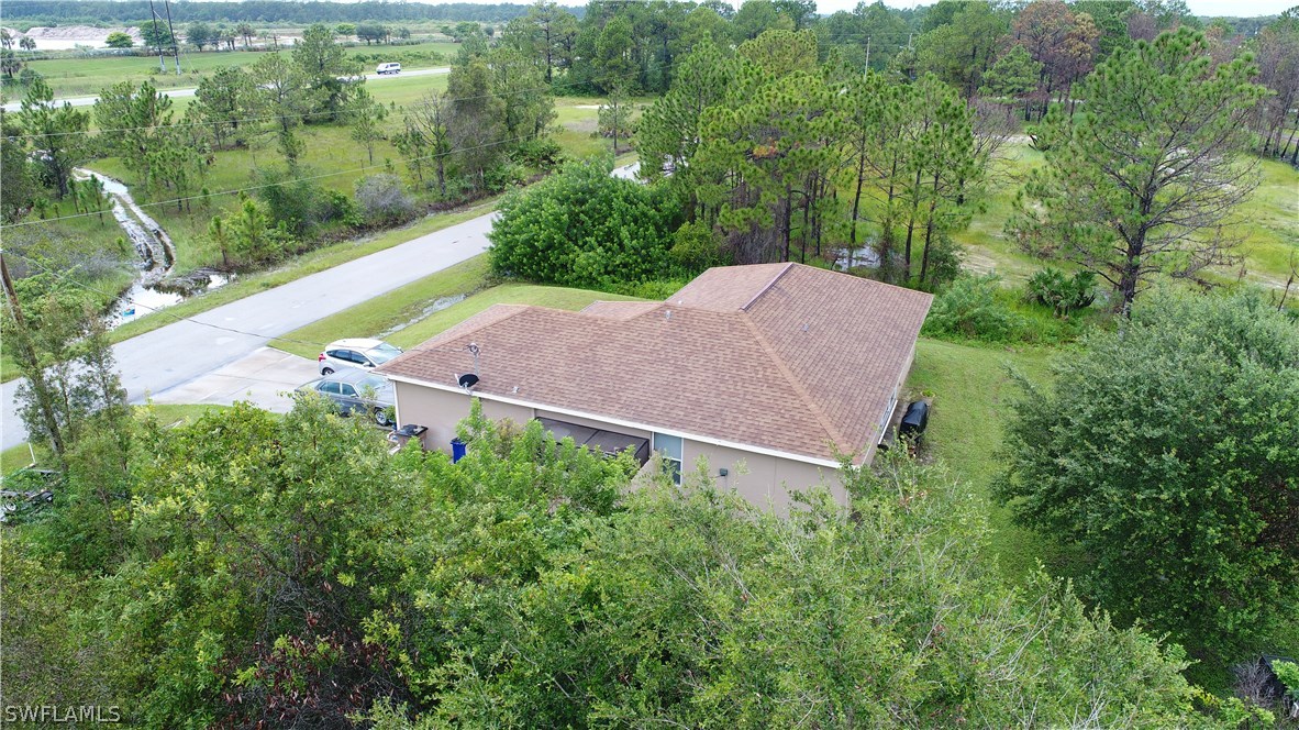 3115 Meadow Road Lehigh Acres, FL 33974 - Photo 3 of 23 an aerial view of a house with yard and outdoor seating