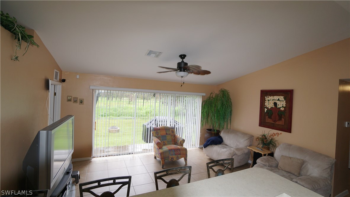 3115 Meadow Road Lehigh Acres, FL 33974 - Photo 5 of 23 a living room with furniture and a large window