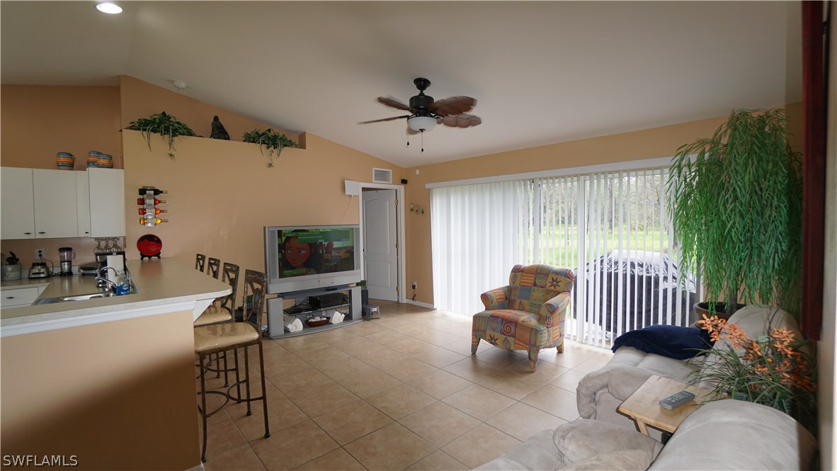 3115 Meadow Road Lehigh Acres, FL 33974 - Photo 6 of 23 a living room with furniture and a flat screen tv