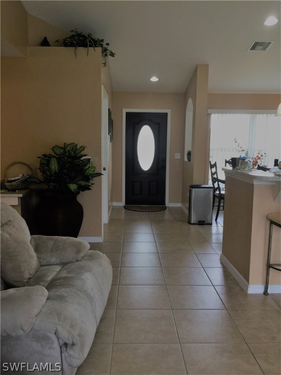 3115 Meadow Road Lehigh Acres, FL 33974 - Photo 10 of 23 a living room with a couch and a stove
