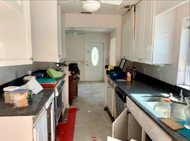 a kitchen with a sink stove and cabinets