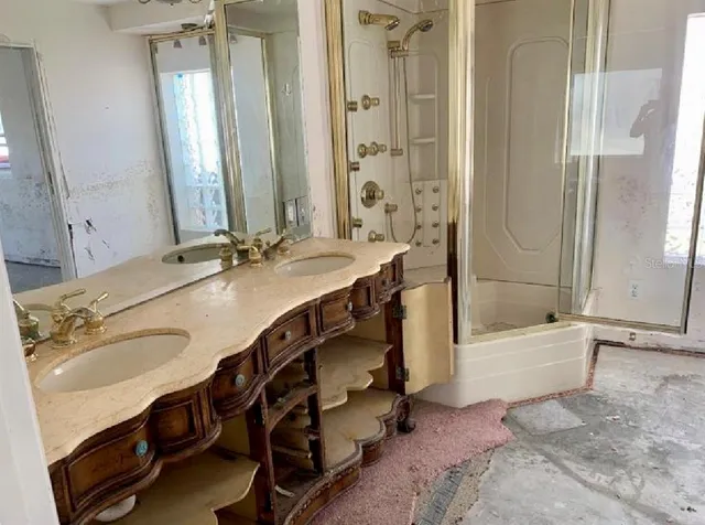 a bathroom with a tub sink and mirror