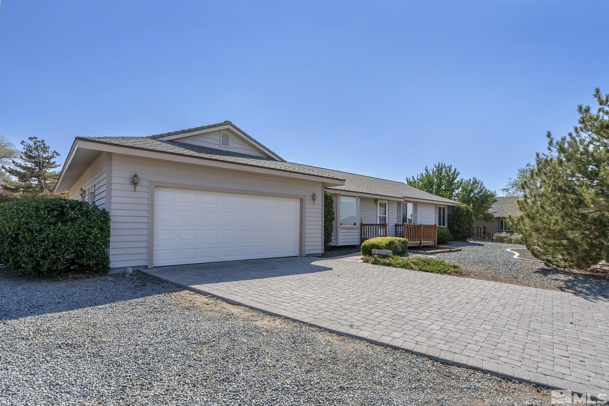1090 Lavender Way Reno, NV 89521 - Photo 1 of 22 a front view of a house with a yard and garage