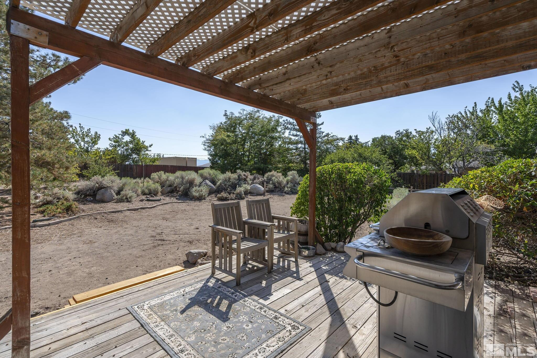1090 Lavender Way Reno, NV 89521 - Photo 13 of 22 a patio with table and chairs and potted plants