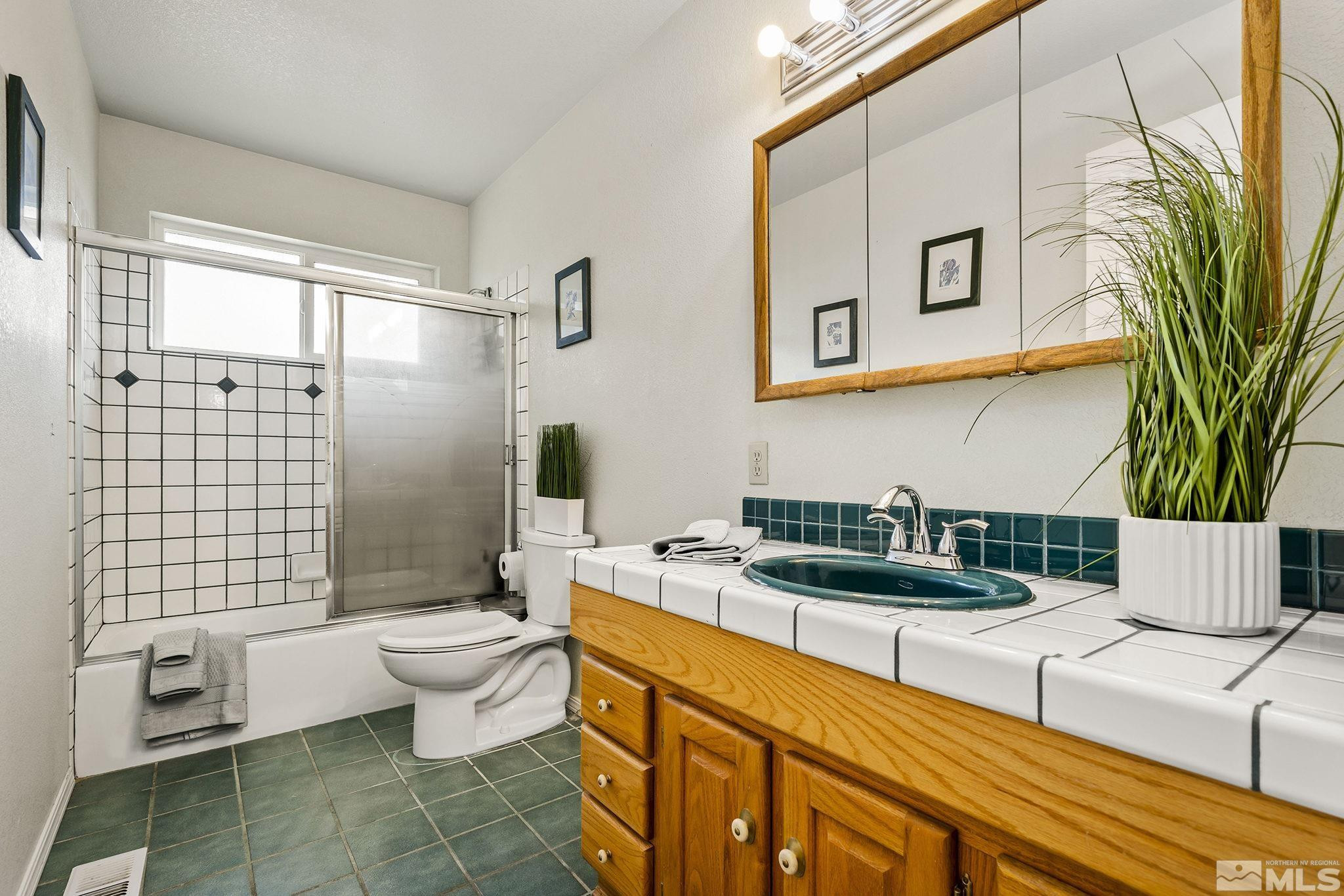 1090 Lavender Way Reno, NV 89521 - Photo 17 of 22 a bathroom with a granite countertop sink and a mirror