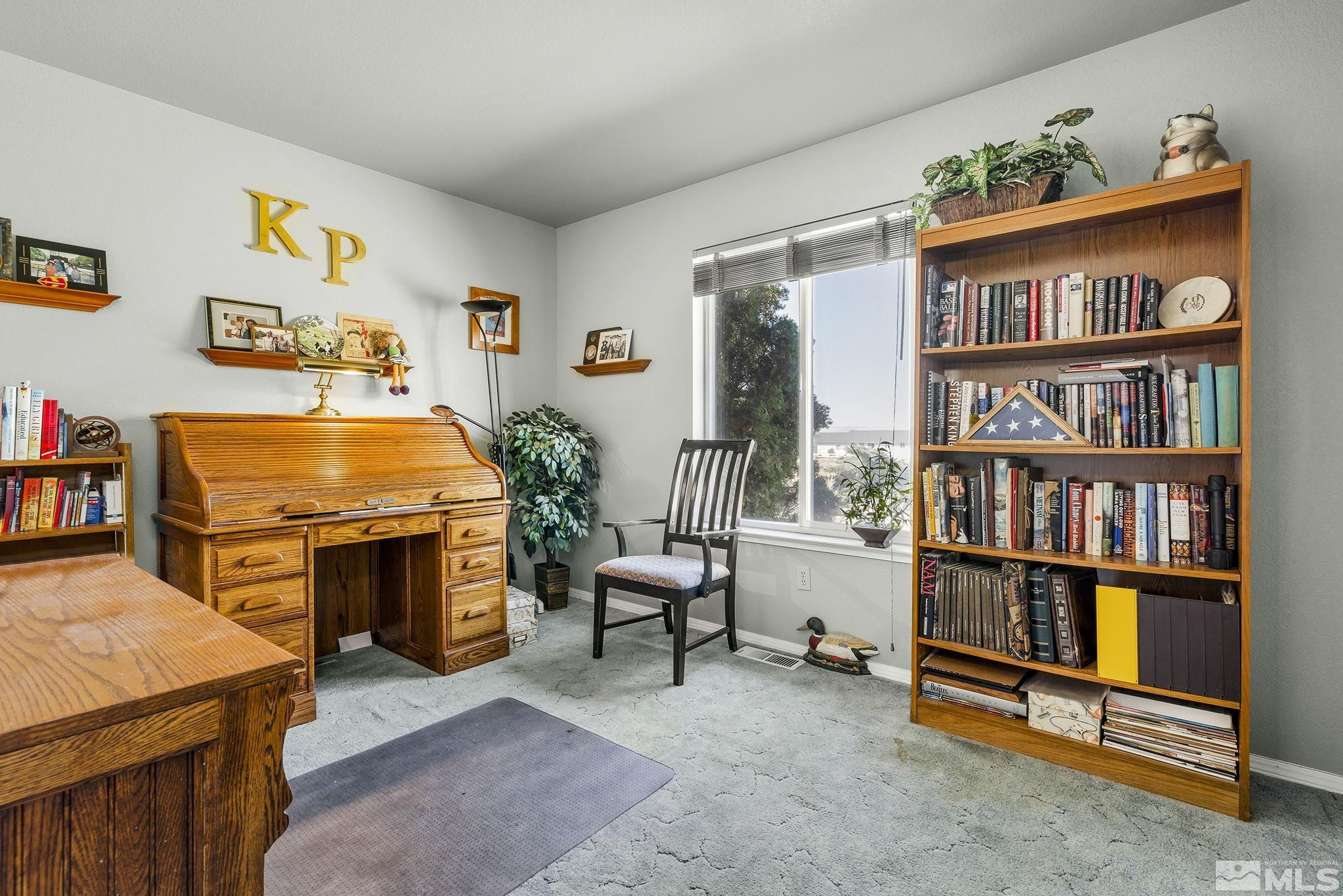 1090 Lavender Way Reno, NV 89521 - Photo 18 of 22 a room with furniture and a book shelf