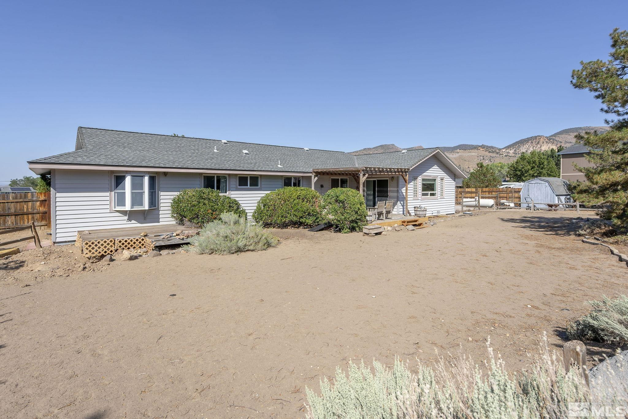 1090 Lavender Way Reno, NV 89521 - Photo 20 of 22 a front view of a house with a yard