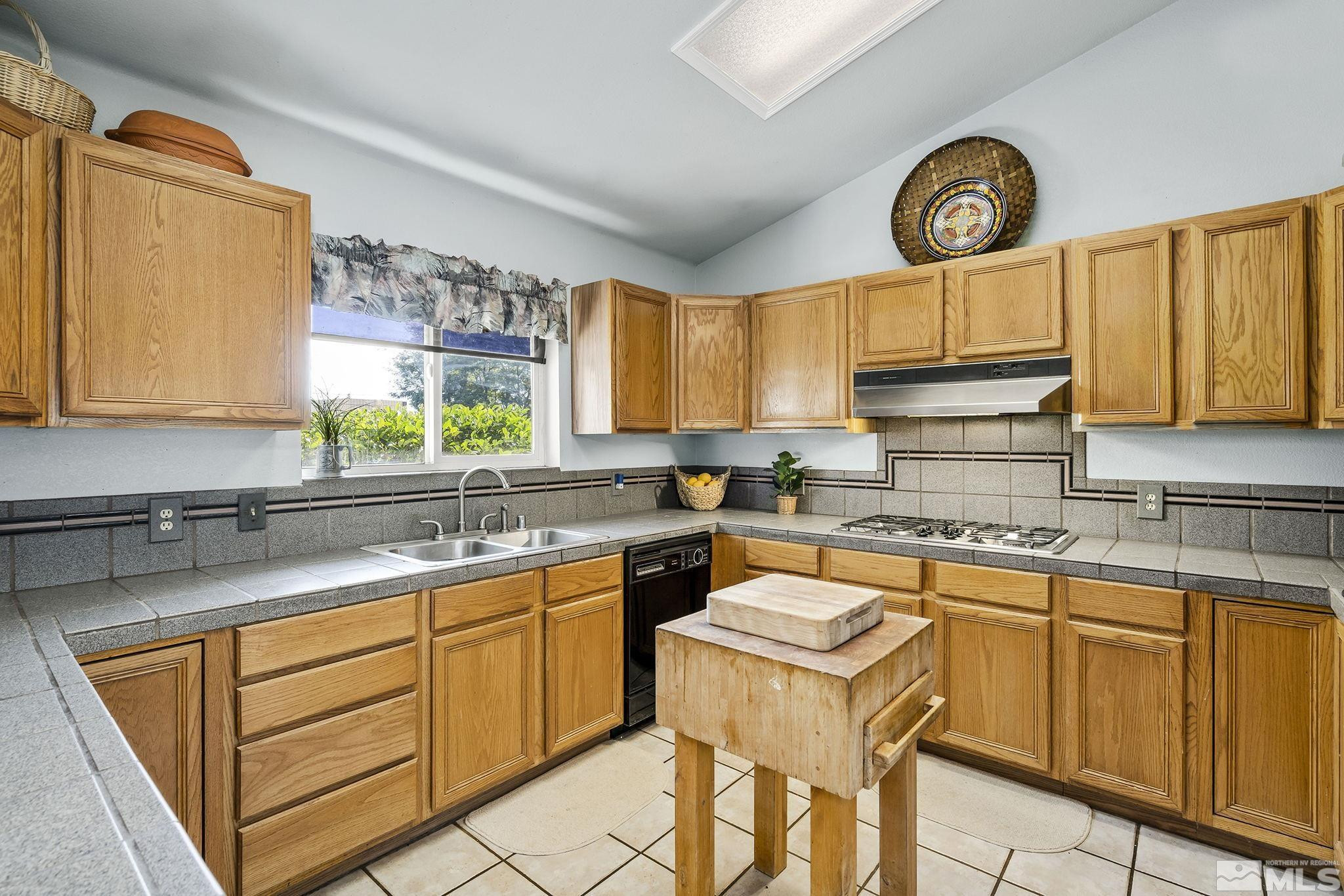 1090 Lavender Way Reno, NV 89521 - Photo 7 of 22 a kitchen with a sink cabinets and window