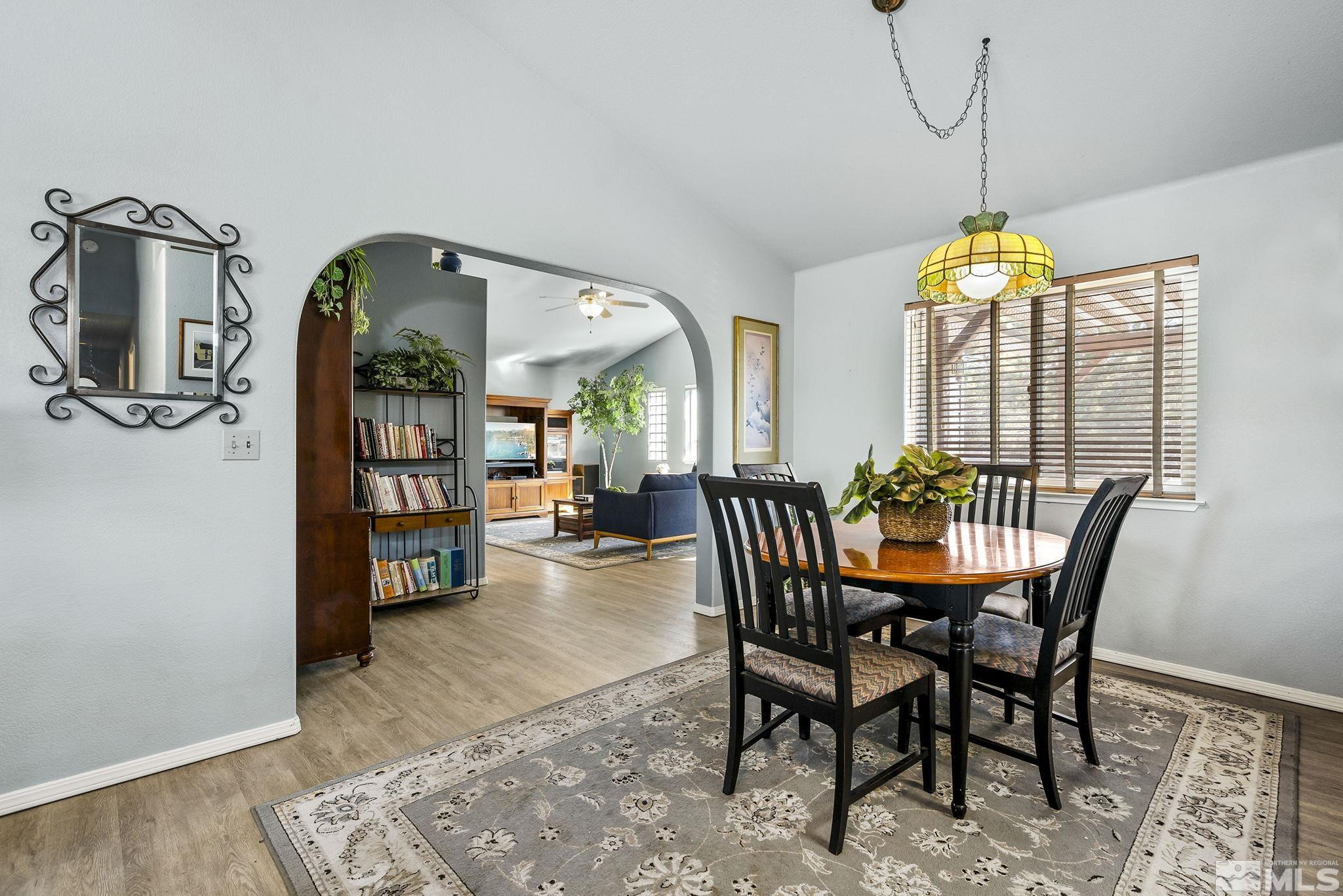 1090 Lavender Way Reno, NV 89521 - Photo 9 of 22 a dining room with furniture a chandelier and wooden floor