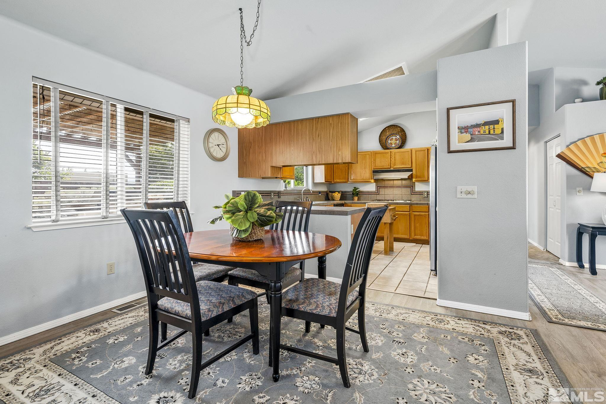 1090 Lavender Way Reno, NV 89521 - Photo 10 of 22 a view of a dining room with furniture window and wooden floor