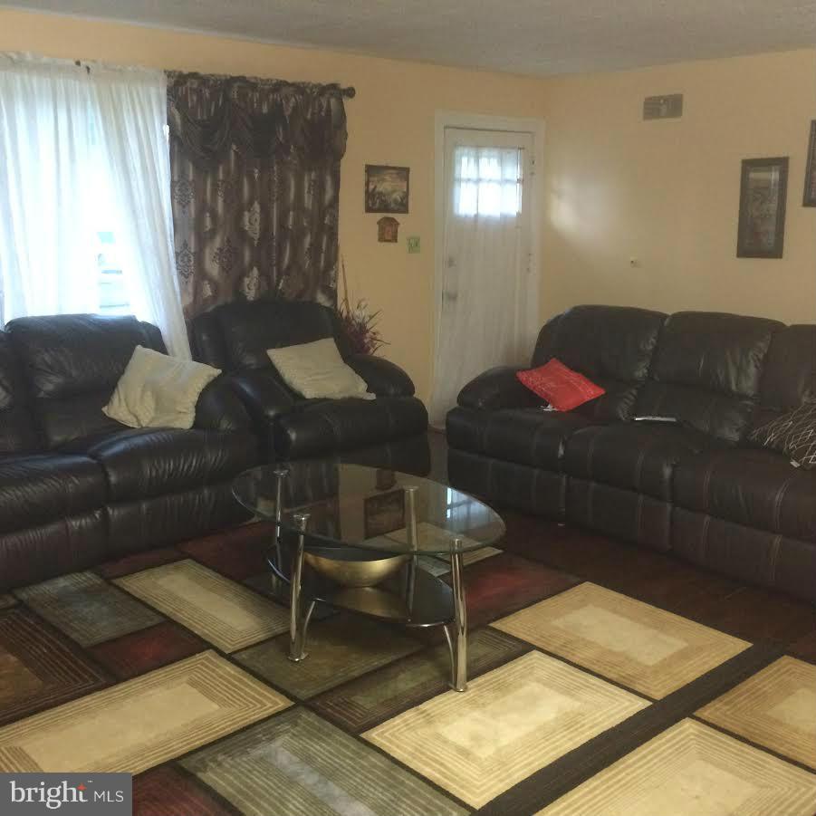 6505 Woodley Road Clinton, MD 20735 - Photo 8 of 12 a living room with couch and a table
