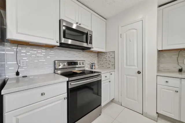 a stove top oven sitting inside of a kitchen