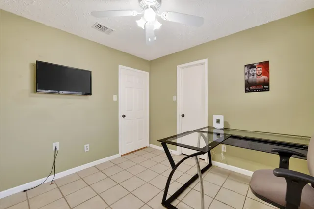 a bathroom with a granite countertop toilet sink and mirror