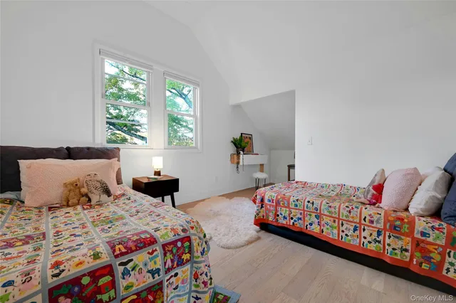 a living room with furniture a chandelier and a window
