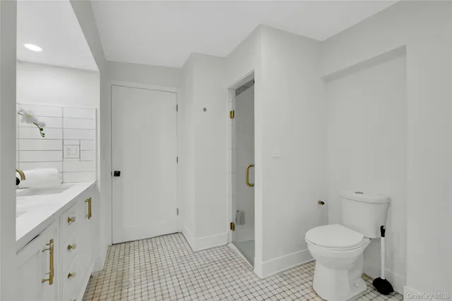 a bathroom with a sink mirror and toilet