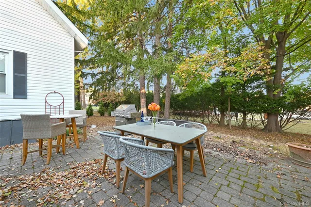 a backyard of a house with table and chairs