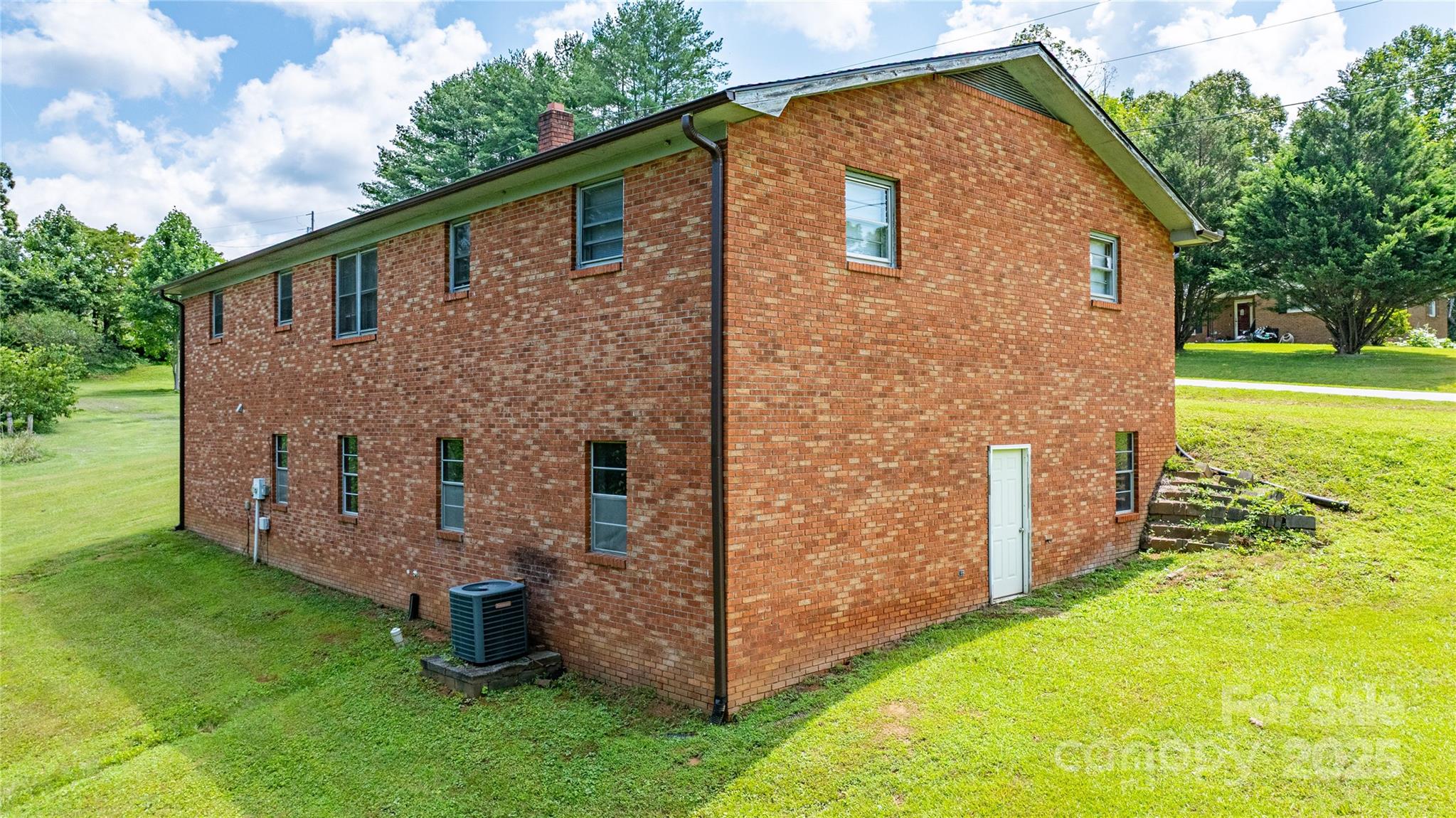 72 Cooper Drive Nebo, NC 28761 - Photo 3 of 18 a front view of a house with garden