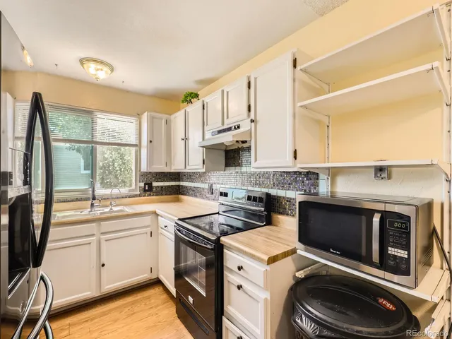 a kitchen with a sink appliances and cabinets