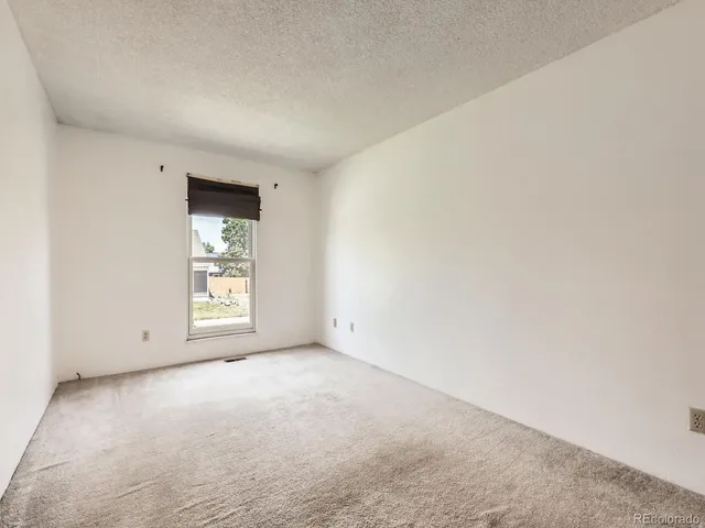 a view of a hallway with workspace and wooden floor