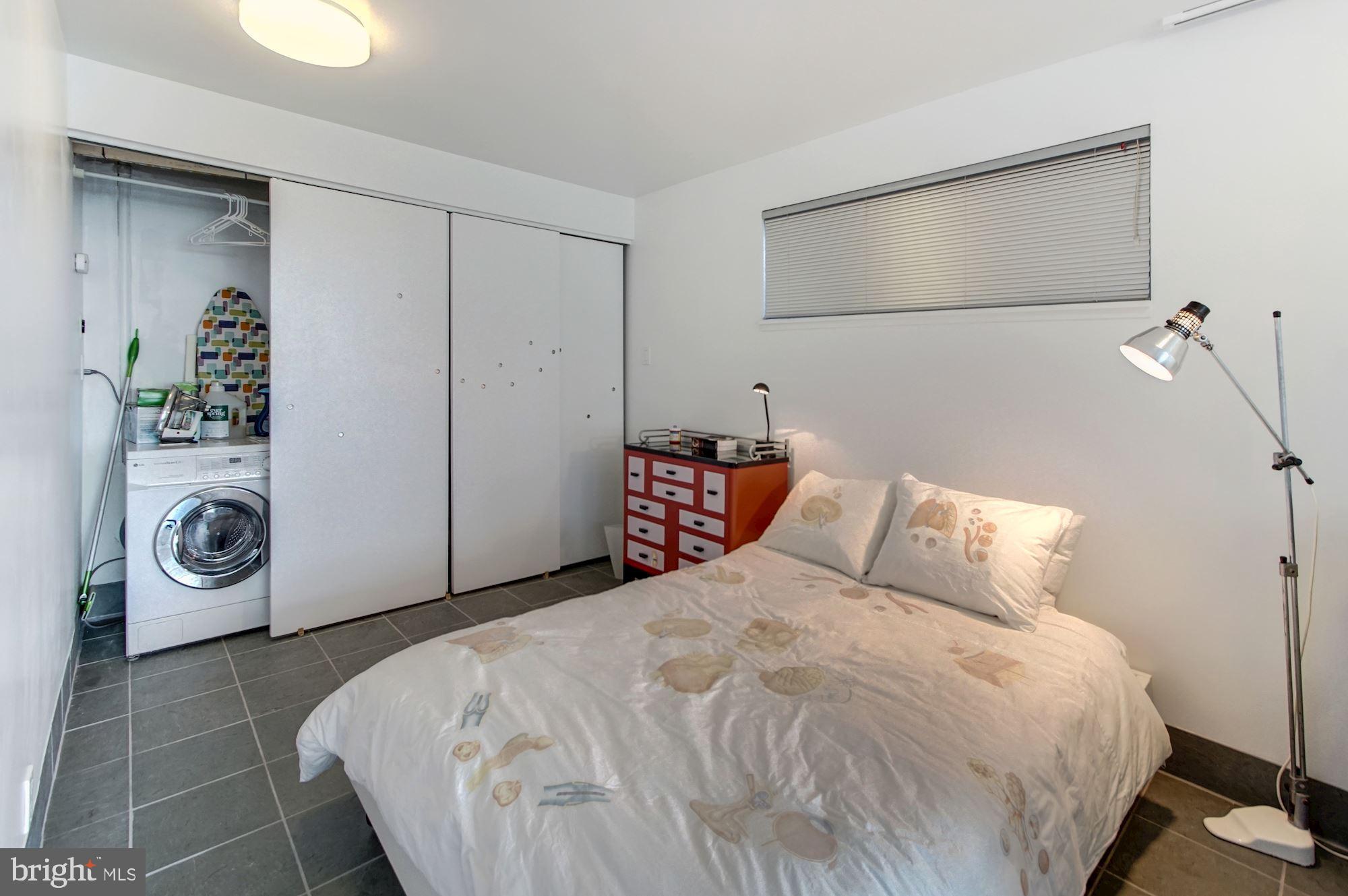 2148 Cedar Road Port Republic, MD 20676 - Photo 26 of 55 a bedroom with a bed and a washing machine with closet