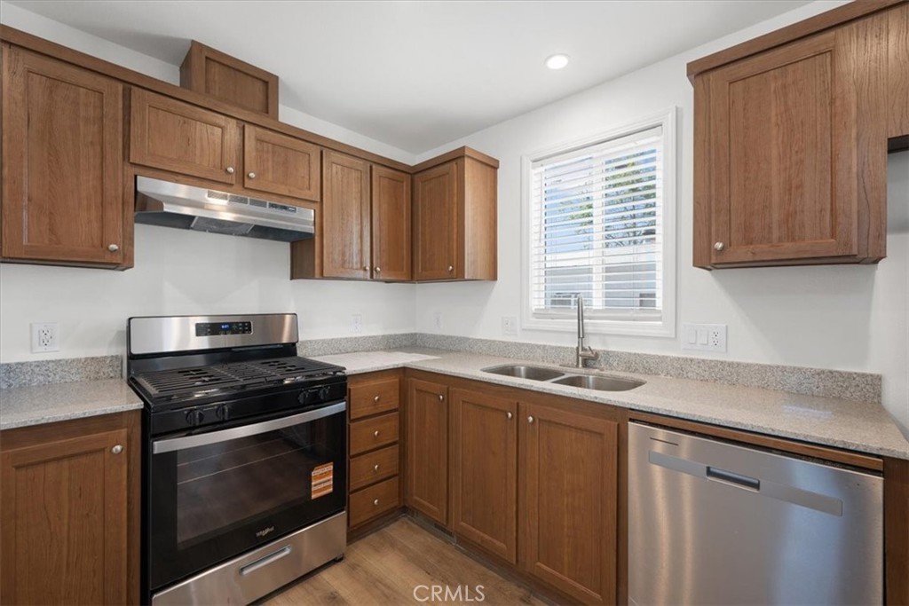1255 Orcutt Road, Unit B27 San Luis Obispo, CA 93401 - Photo 11 of 24 a kitchen with stainless steel appliances granite countertop a sink stove and cabinets