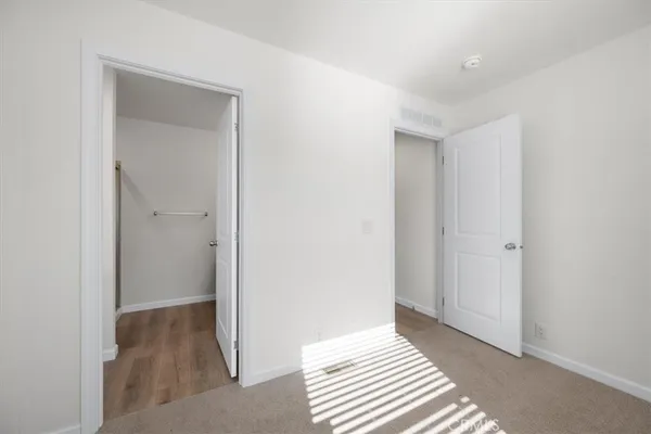 a view of a room with wooden floor and cabinet