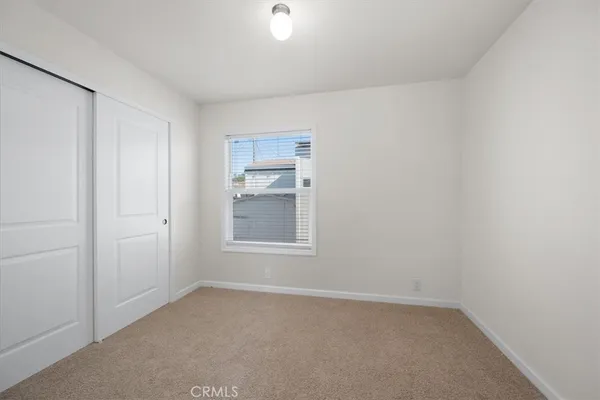 an empty room with a empty space and windows