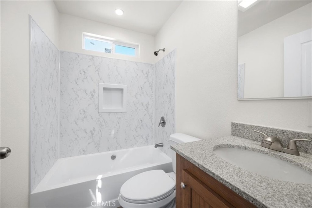 1255 Orcutt Road, Unit B27 San Luis Obispo, CA 93401 - Photo 22 of 24 a bathroom with a granite countertop bathtub shower sink mirror vanity and toilet