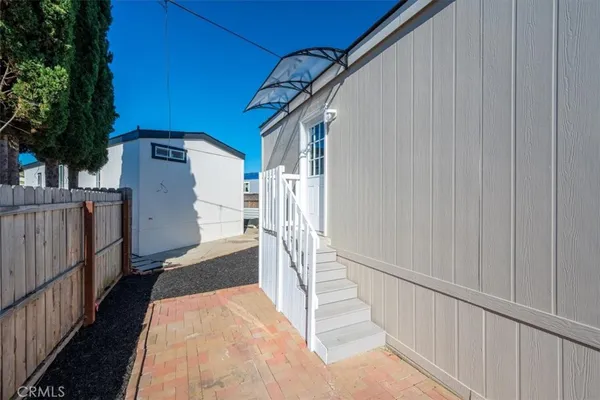 a view of a house with wooden fence