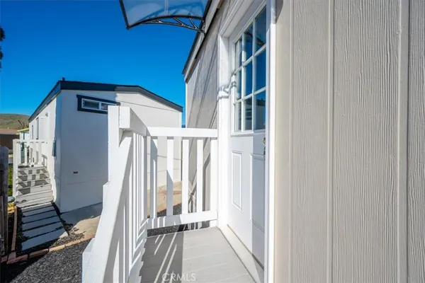 a view of an entryway with wooden floor and door