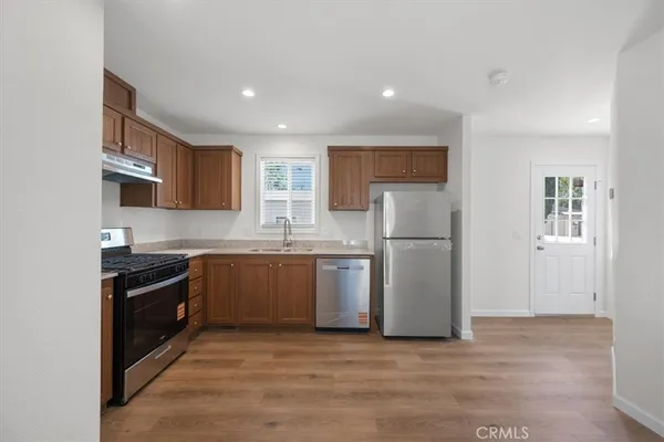 a kitchen with a refrigerator and a sink