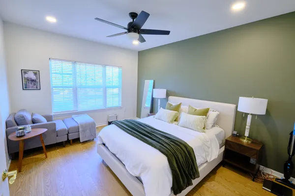 a bedroom with bed and a chandelier