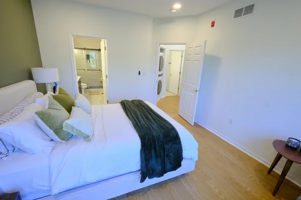 a bedroom with a bed and a chair