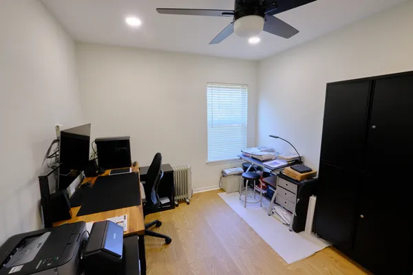 a view of a workspace with furniture and a air conditioner
