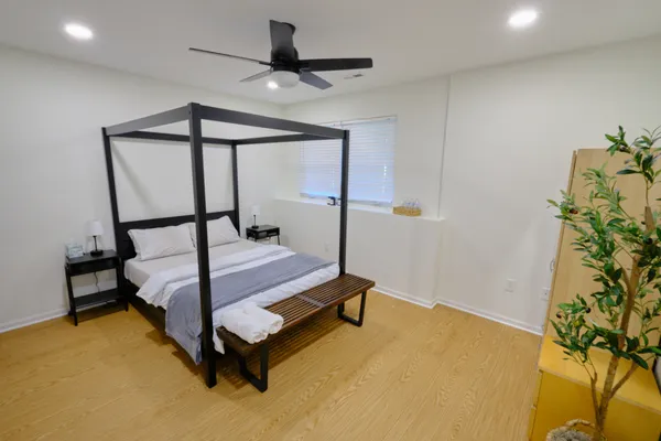a bedroom with a bed and a potted plant