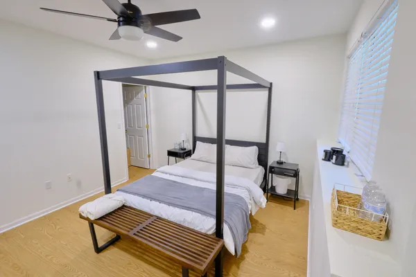 a bedroom with a bed and a chandelier