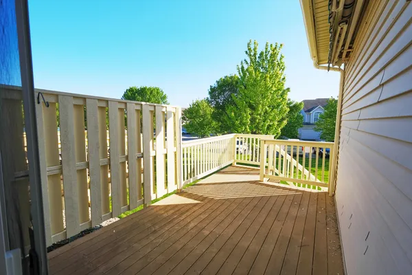 a balcony with wooden floor