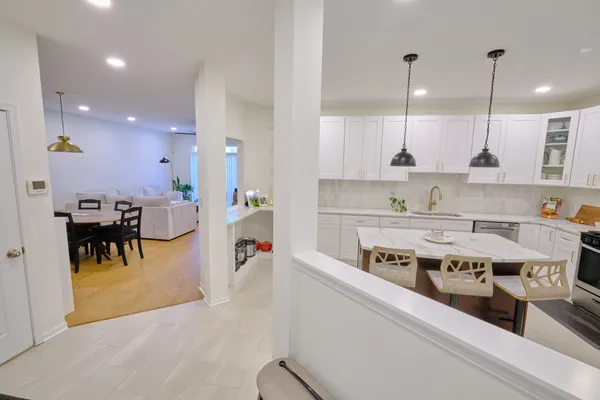 a kitchen with stainless steel appliances granite countertop a sink a stove and a refrigerator