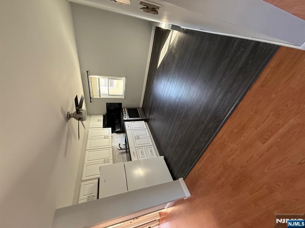 618 8th Street, Unit 2 Lyndhurst, NJ 07071 - Photo 2 of 10 a view of empty room with wooden floor and kitchen view