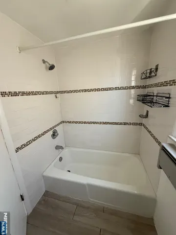 a bathroom with a bathtub and a shower