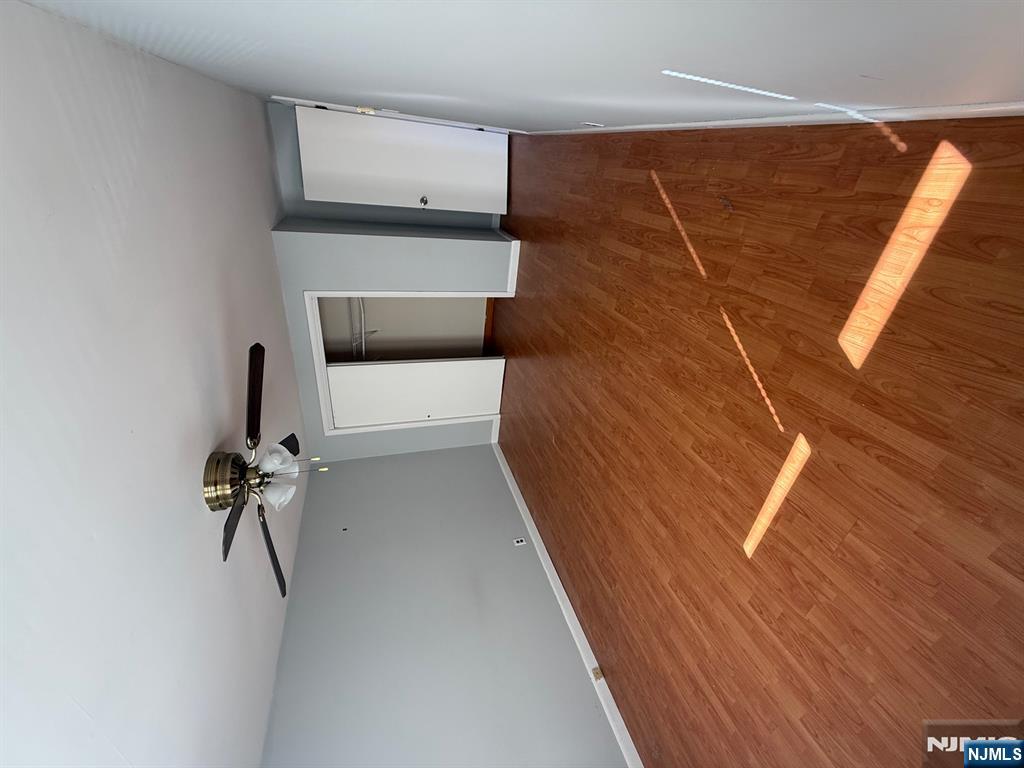 618 8th Street, Unit 2 Lyndhurst, NJ 07071 - Photo 7 of 10 a view of a room with a ceiling fan and wooden floor