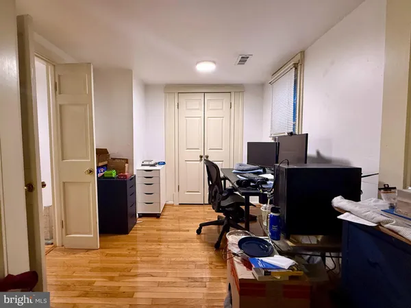 a view of a workspace with furniture and a window