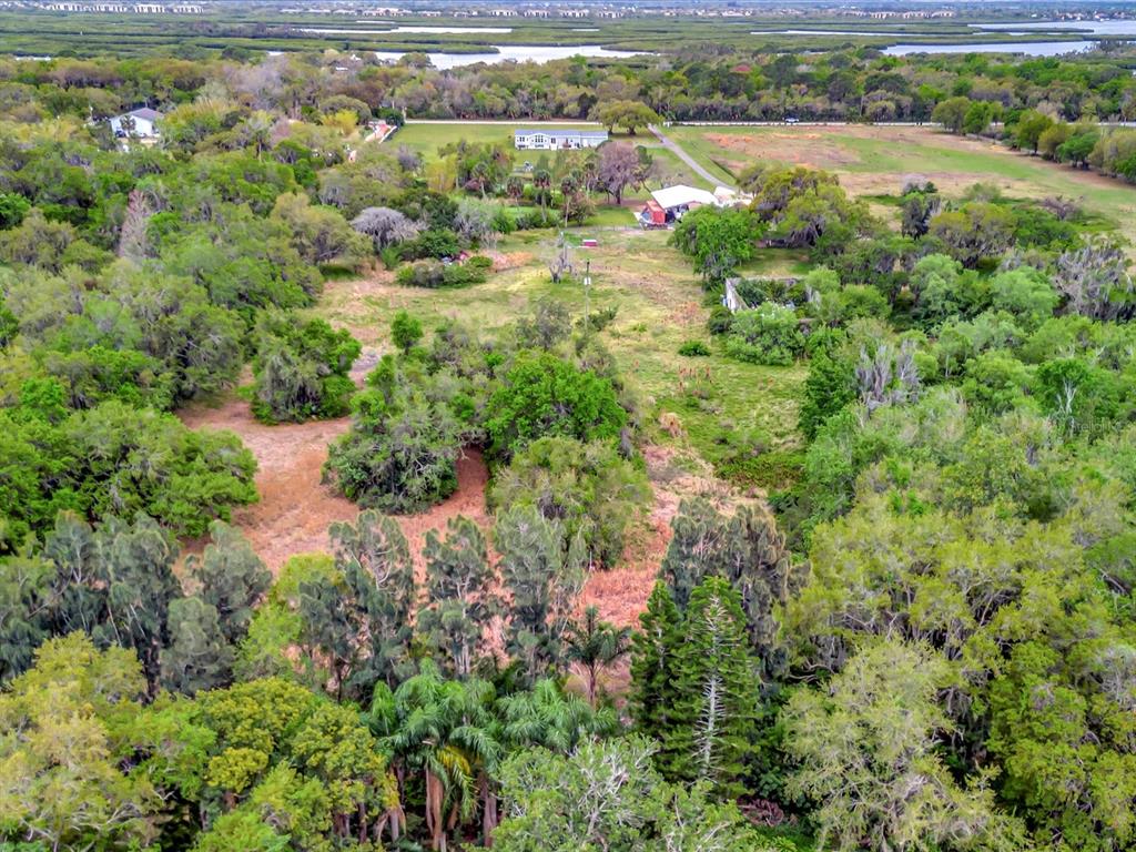 9120 25th Street East Parrish, FL 34219 - Photo 17 of 28 an aerial view of residential houses with outdoor space and trees