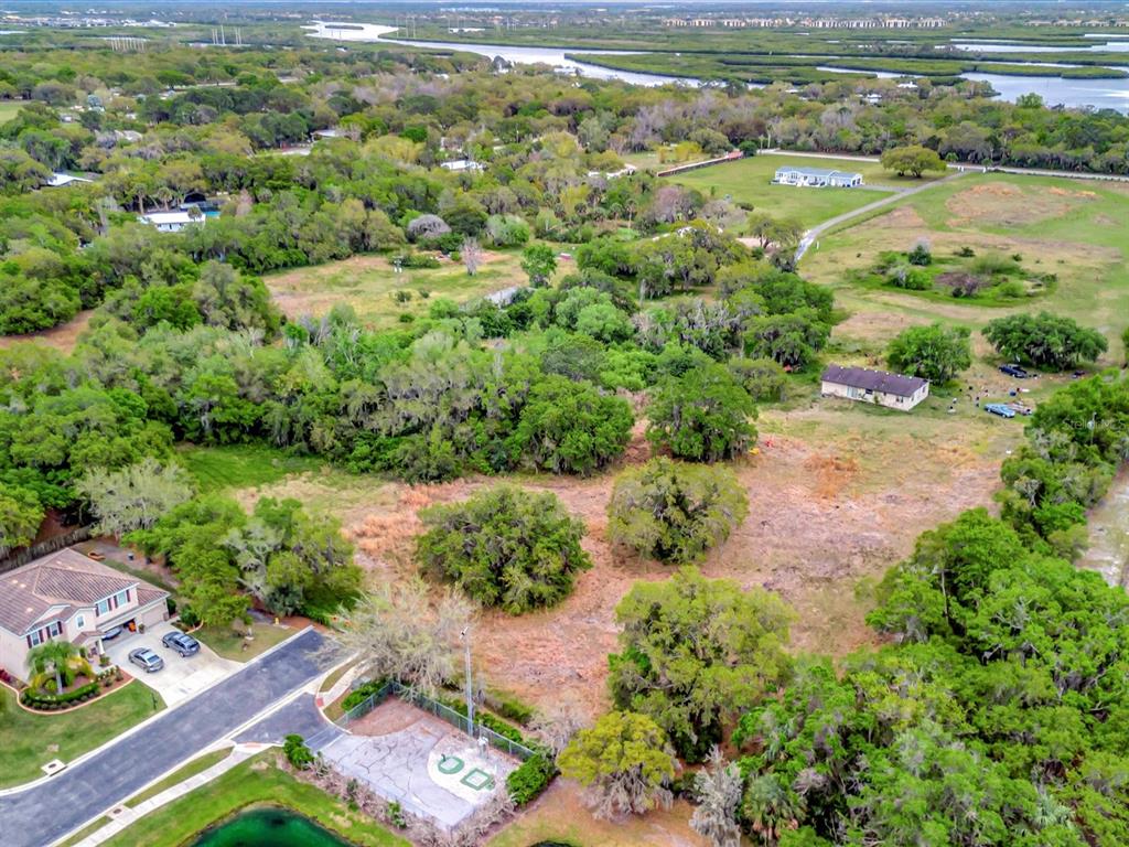 9120 25th Street East Parrish, FL 34219 - Photo 21 of 28 an aerial view of residential houses with outdoor space and swimming pool