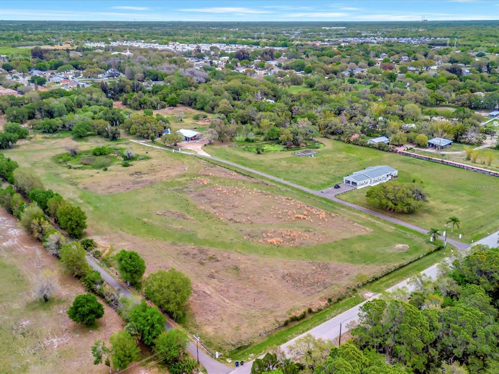 9120 25th Street East Parrish, FL 34219 - Photo 3 of 28 an aerial view of residential houses with outdoor space and trees