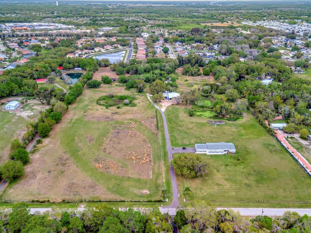 9120 25th Street East Parrish, FL 34219 - Photo 10 of 28 an aerial view of residential houses with outdoor space and trees